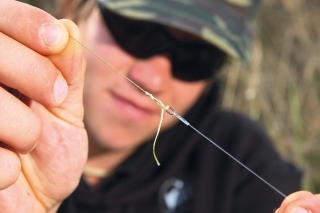 Na krúžok ukončujúci hotový fluorocarbonový nadväzec uviažem klasickým „pružným uzlom“ splietanú šnúrku.